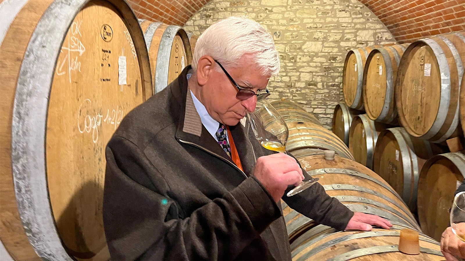 Darrell Corti sniffs a glass of sweet wine in the cellars of Vignalta winery in Italy.
